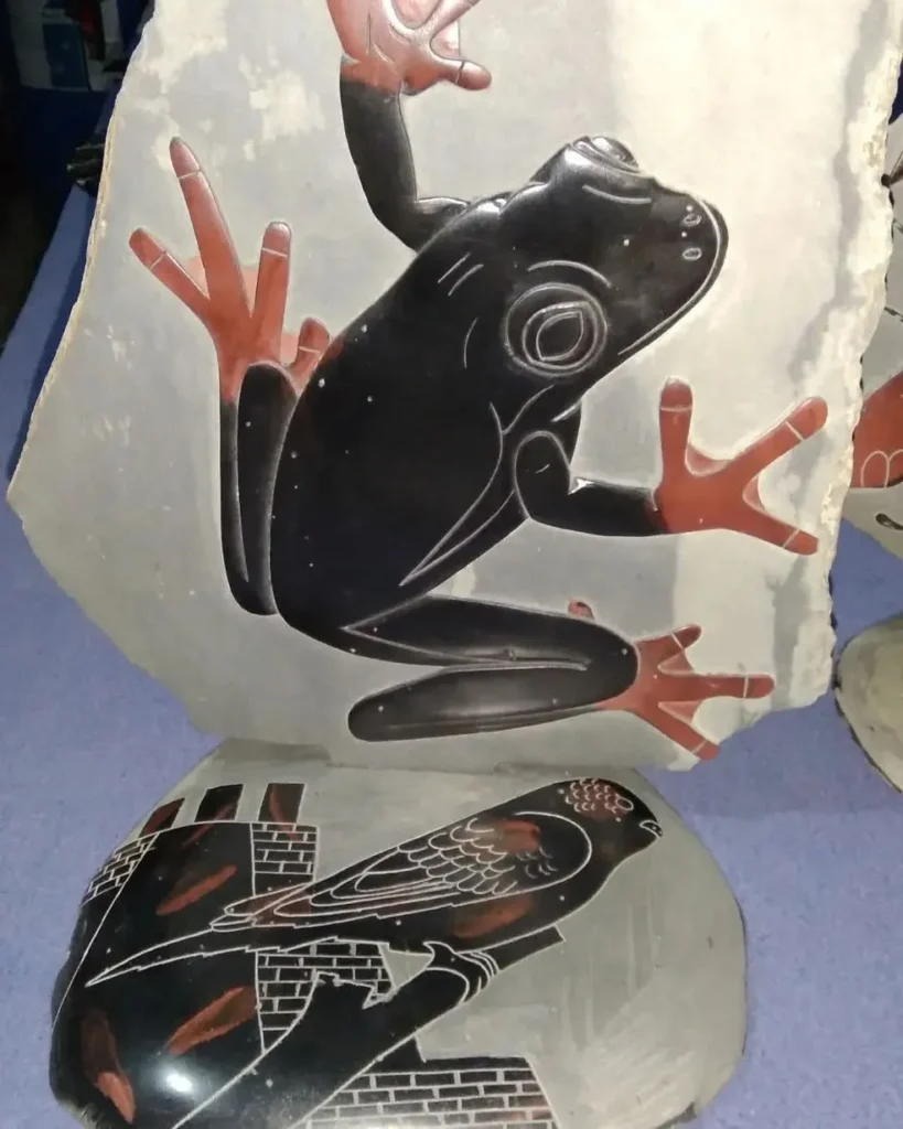 Stone Carvings of Frog Black withe Brown Feet, Second Piece of a Black Bird on a tree Limb looking right