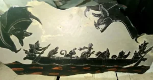 Stone Carvings of Canoe with Animals Side view and Two Large Bats Looking down on Canoe