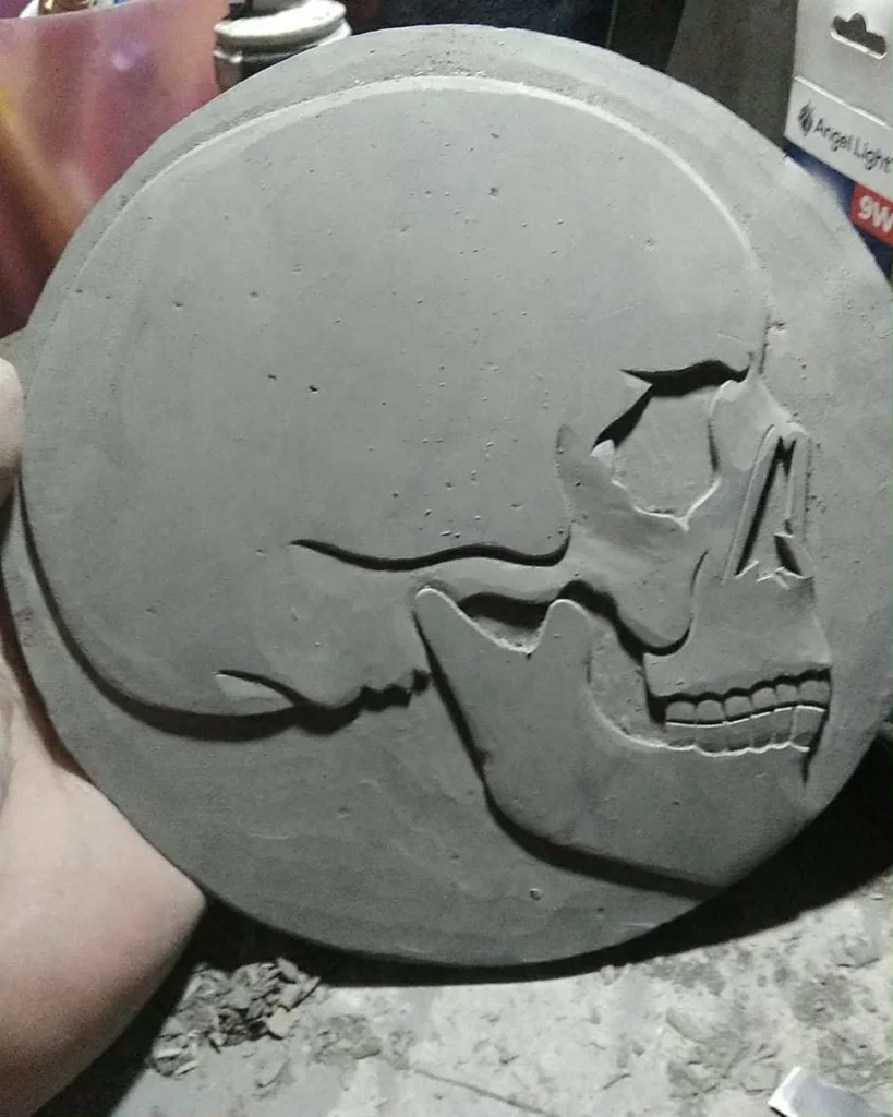 Stone Carvings of Profile of a Skull Gray on Gray