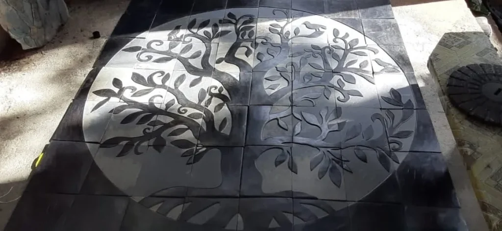 Stone Carving of a Tree with Several Limbs and Large Leaves - Flat view with light and shadow areas