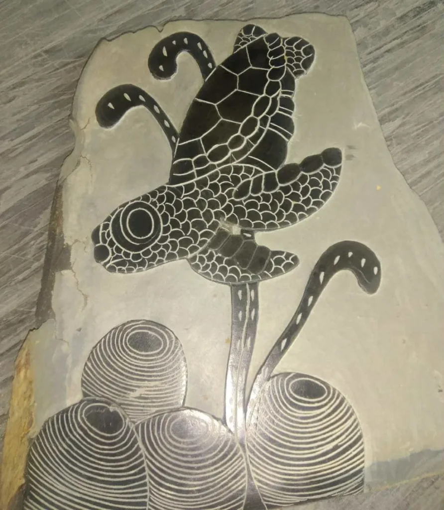 Hancel Stone Carving Black Turtle Swimming Down and Left to Reef on Gray Background