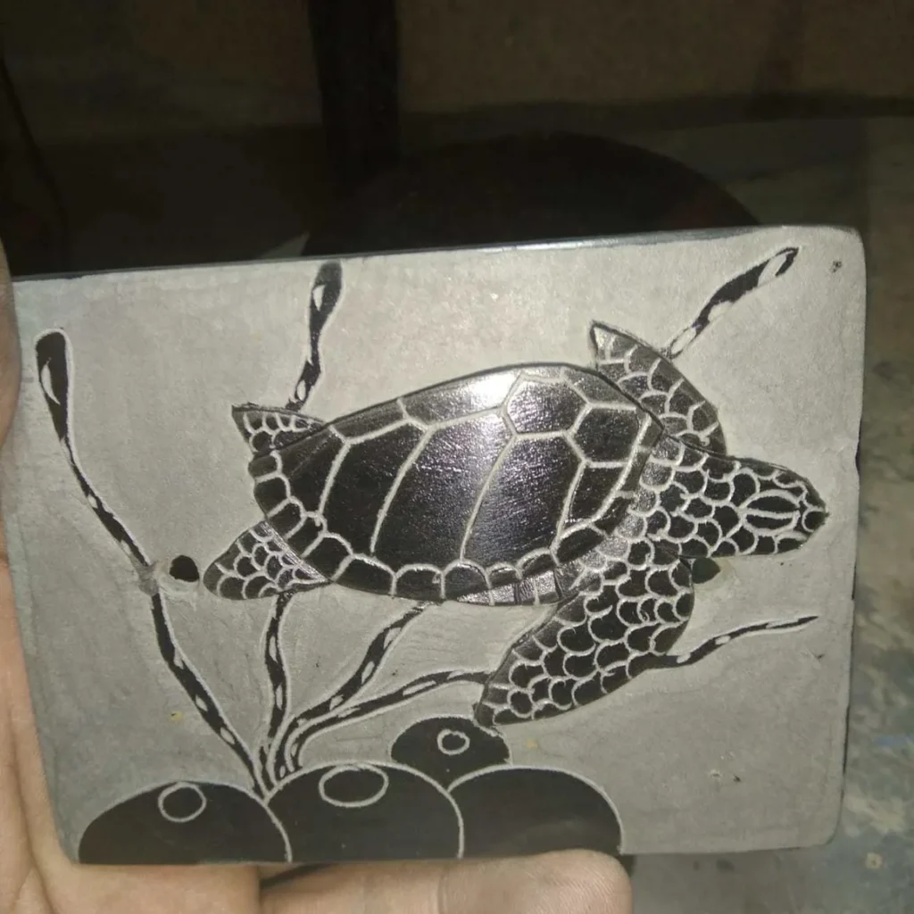 Hancel Stone Carving Black Turtle Swimming Right on Gray Background
